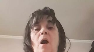 Milf with the black dildo goes up and down