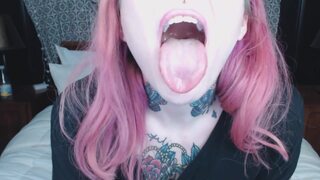 Pink haired girl holds mouth wide open for you ;)