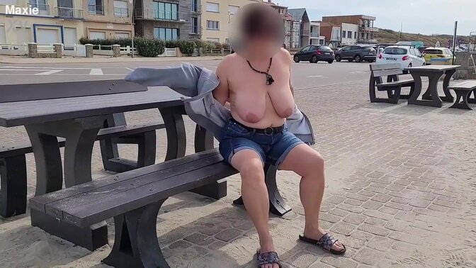 A busty mom exposes her big saggy boobs in the street.