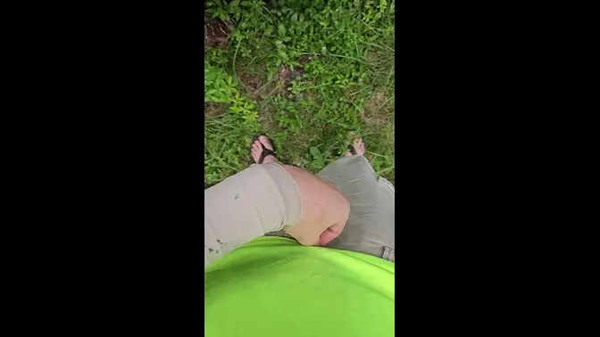 Aaron Skeetman pees in the grass in flip flops