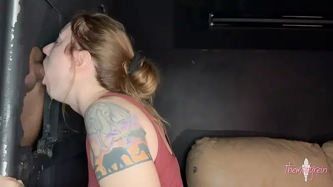 Amateur redhead Misty sucks cock through a glory hole