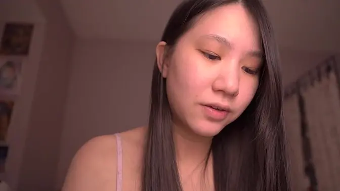 Asian solo girl studies bible while playing with her hair