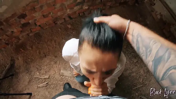 Black Lynn deepthroats cock in a dirty abandoned building