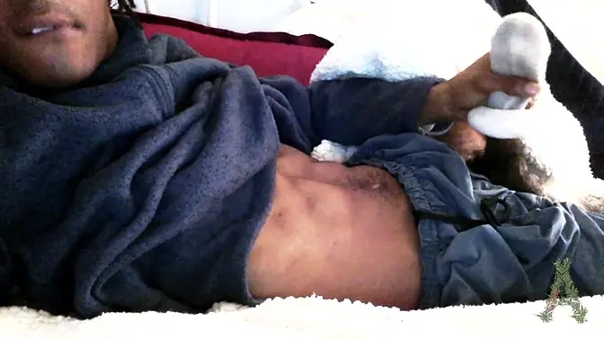 Black stud gives a horny sockjob under a cozy blanket