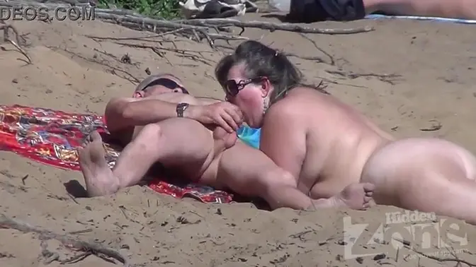 Blonde sunbathing on nudist beach GIVES blowjob