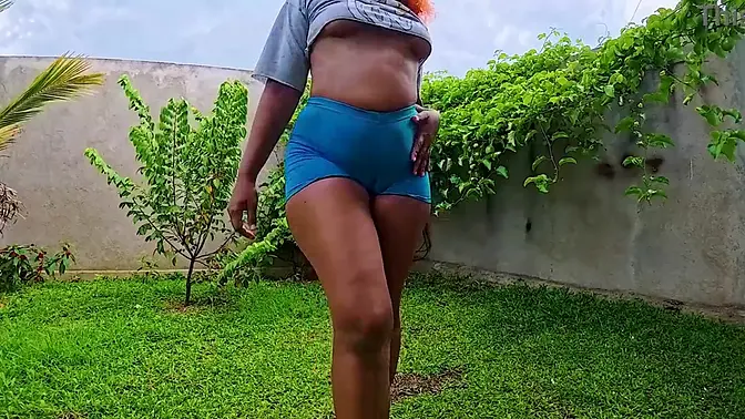 Brown-skinned solo girl with big booty tries on crop top and shorts