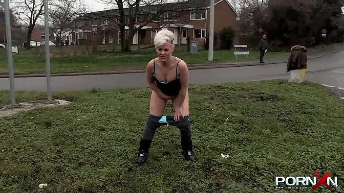 Busty mature blonde pissing in public
