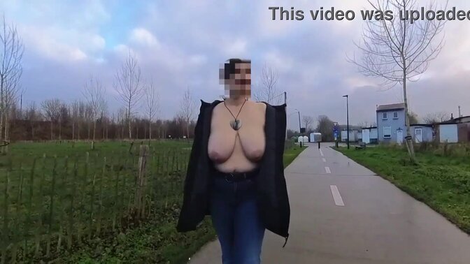 Busty MILF flaunts her big natural tits in the street