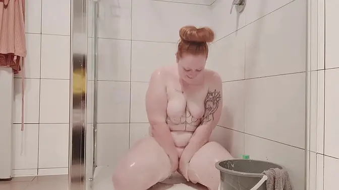 Chubby red head has to bathe from a bucket because her hot water broke