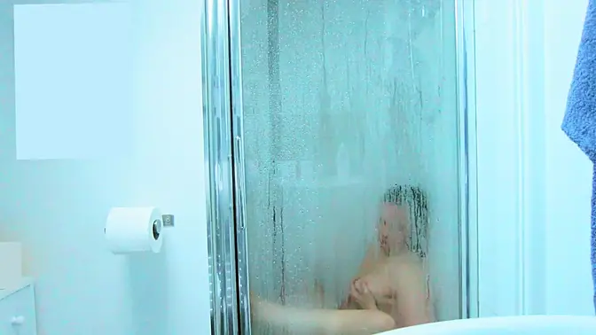 Curvy milf enjoys toy in the shower