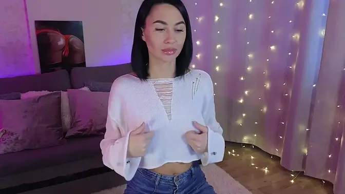 Cute brunette gets soaked while watching