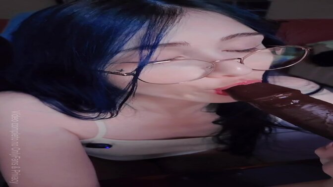 Cute girl gives a deepthroat blow job with big dick toy