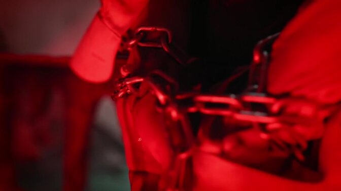 Dominant woman shoves submissive's cock in chastity cage