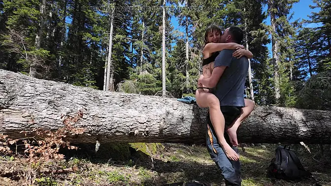 Eastern European couple gets intimate under the tree on their hike