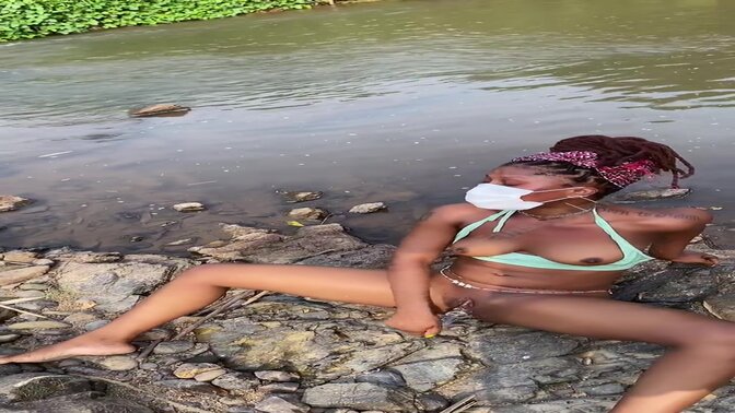 Ebony MILF masturbates by a stream and shows off her big booty while using