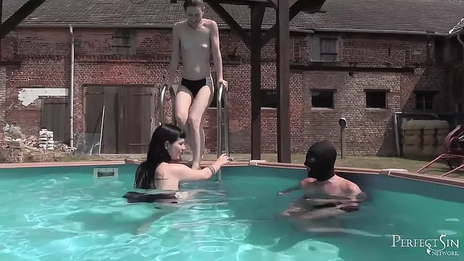 Evil German Goddess dominates her friend in the pool