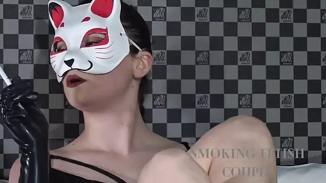 Foot mistress smokes while giving condom-covered blowjob