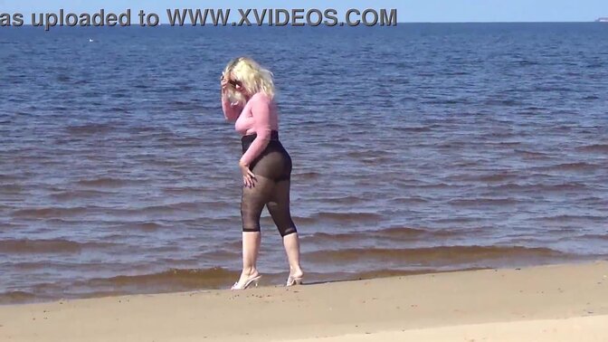 Funny MILF sucks and shows off big tits at the beach