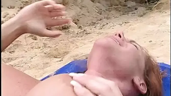Gorgeous red-headed babe gets her pussy licked on the beach