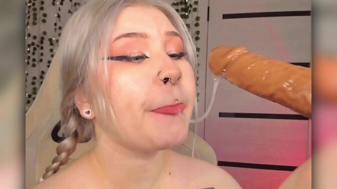 Horny schoolgirl learns how to suck and salivate on a slippery dildo in an