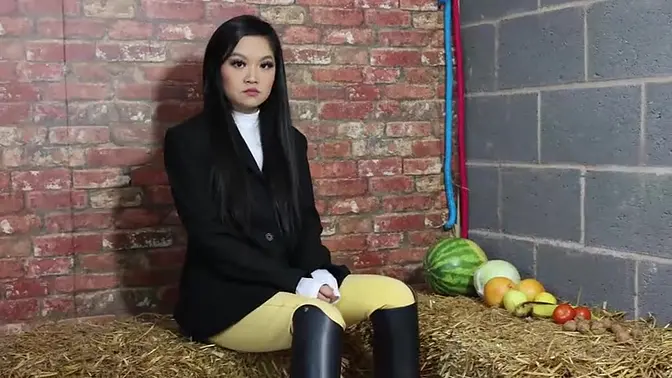 Horny Slut Equestrian Louisa crushing fruit wearing boots