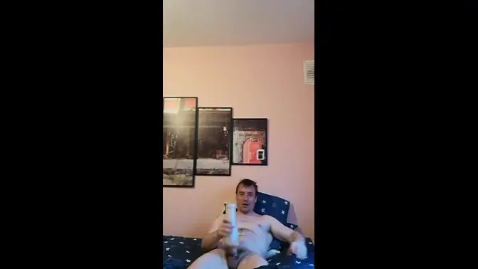 Irish stud LongJohn0Hara wanks his big cock in Fleshlight lying on bed