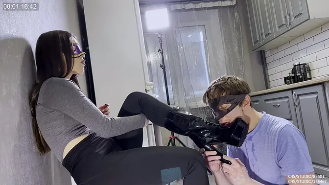 Kinky slave licks powerful boots