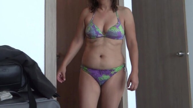 Latin mom shows off in a swimsuit on the beach