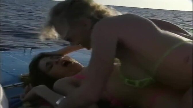 Lesbian lovers lick and finger each other on the USA beach in a classic