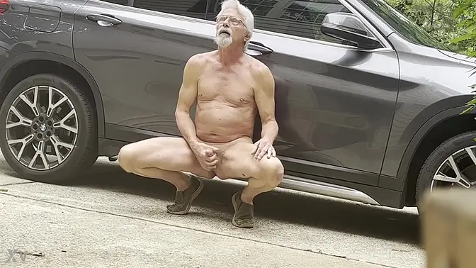 Mature man wanks his cock in public car parking