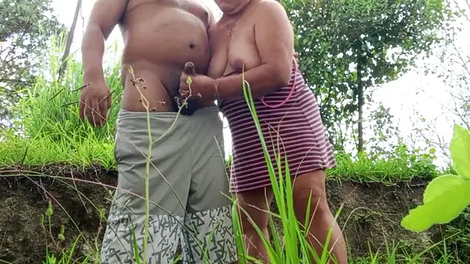 Mature MILF deep throats and gives a wet handjob