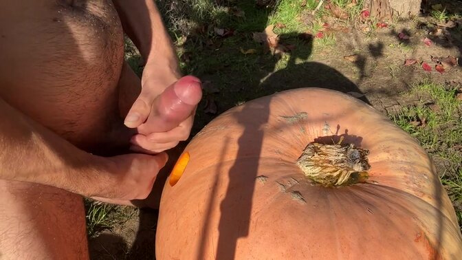 Naked guy pumps huge cock into Halloween pumpkin