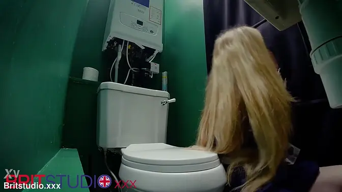 Nurse with long hair deepthroats and swallows cum at the gloryhole