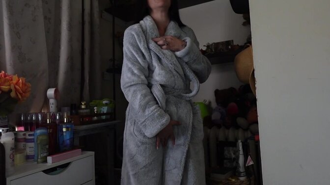 Petite, long-haired brunette MILF teases in her big furry robe 