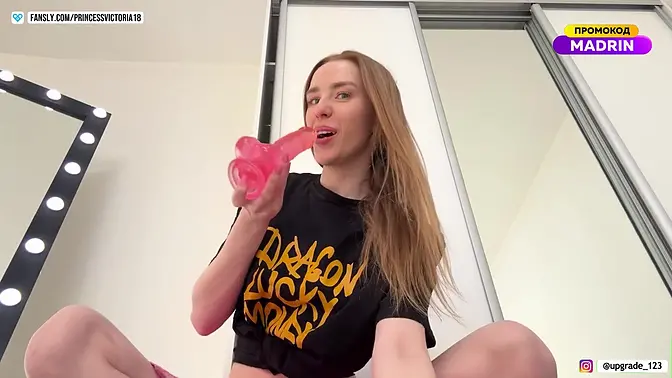 redhead beauty masturbates with a pink dildo and fists her pussy with her hand close-up