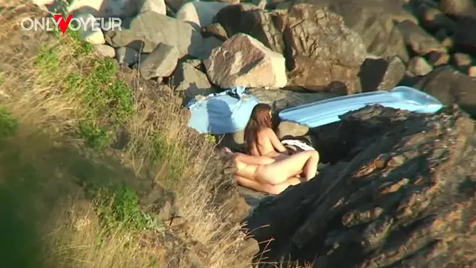 Redheaded couple caught having a horny fuck on the beach