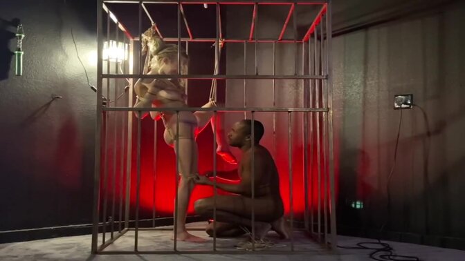 Romantic couple bound by ropes and confined to a cage 