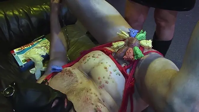 Rubber fetish club scene with dominant male