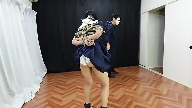 Schoolgirl bound in rope walks the plank while pleasured by a vibrator