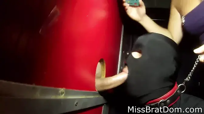 Slave sucks cock at gloryhole with dominant femme fatale