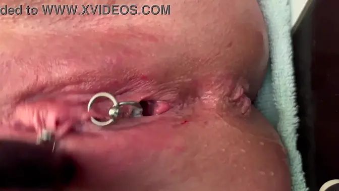 Slick latex gloves rub pierced clit vigorously