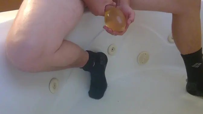 Solo male moaning while wearing condom pissing and cumming in bathtub