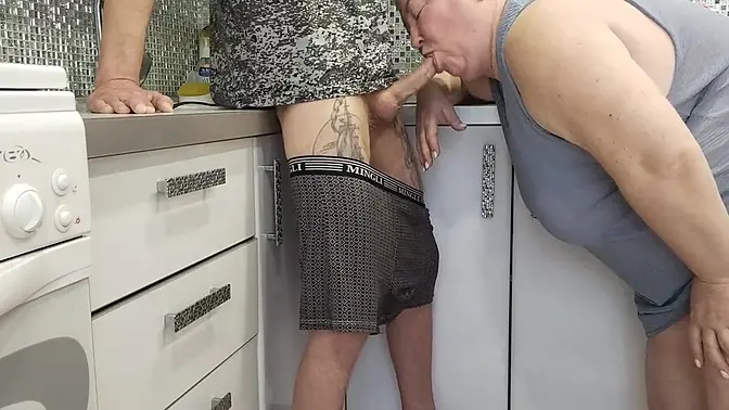 Stepmom blows stepson's cock in the kitchen