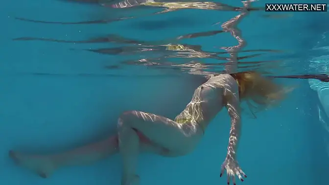 Stunning Latvian beauty strips at the pool and shows off her tight pussy