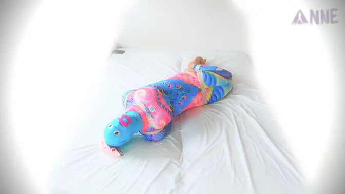 Sultry woman in colorful catsuit tied up and hogtied