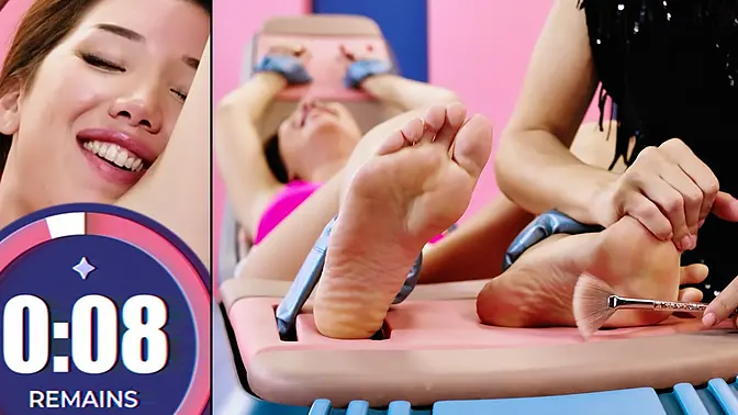 Talia Mint giggles as she tickles Layla's feet