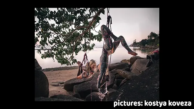 Tattooed babe suspended in Shibari bondage on Thai beach