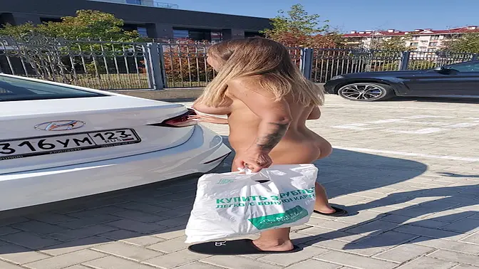 Tattooed Russian nympho flashes her big tits in public car park