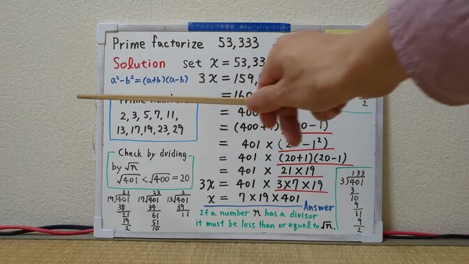 Teacher taps student's digits in a Japanese math lesson