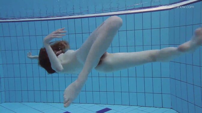 Tiny teen Anna gets wet in a poolside solo scene